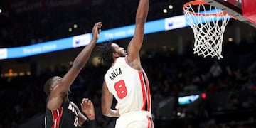 (FILES) In this file photo Trevor Ariza #8 of the Portland Trail Blazers dunks the ball alongside Bam Adebayo #13 of the Miami Heat in the first quarter during their game at Moda Center on February 09, 2020 in Portland, Oregon\u002E - Portland Trail Blazers veteran Trevor Ariza and Washington Wizards forward Davis Bertans have both opted to skip the NBA's planned season relaunch in Orlando as Florida battles a surge in coronavirus cases, reports said June 22\u002E (Photo by Abbie Parr / GETTY IMAGES NORTH AMERICA / AFP)
