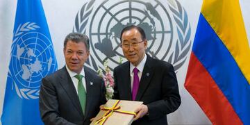 FILE - In this Monday, Sept. 19, 2016 file photo President Juan Manuel Santos of Colombia, left, presents a copy of a peace agreement that was forged in his country to United Nations Secretary-General Ban Ki-moon during a meeting at the United Nations headquarters. Colombian President Juan Manuel Santos has won Nobel Peace Prize it was announced on Friday Oct. 7, 2016. (AP Photo/Craig Ruttle)