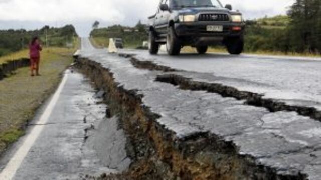 CHI005. CHILOE (CHILE), 25/12/2016.- Personas transitan por una carretera destruida hoy, domingo 25 de diciembre de 2016, en Tarahuin, en la isla de Chilou00e9, localidad distante a 1.250 km. al sur de Santiago (Chile). El terremoto de magnitud 7,6 registrado