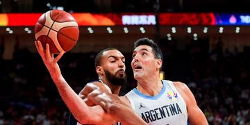 TOPSHOT - France's Rudy Gobert (L) fights for the ball with Argentina's Luis Scola during the Basketball World Cup semi-final game between Argentina and France in Beijing on September 13, 2019\u002E (Photo by Greg Baker / AFP)