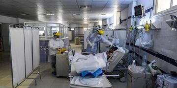 Nurses clad in PPE (personal protective equipment) tend to an intubated COVID-19 coronavirus disease patient in an intensive care unit (ICU) at a hospital in the town of Gabes in Tunisia's southwestern governorate of the same name on August 26, 2020\u002E - The novel coronavirus outbreak in Tunisia, which had been contained by imposing strict measures early on, has seen a spike in cases since reopening borders in late June\u002E It has put the spotlight on struggling health services in the southeast, with residents and doctors decrying a lack of equipment and medics in El-Hamma, some 500 kilometres (around 310 miles) south of the capital, making it one of the national virus epicentres\u002E (Photo by FETHI BELAID / AFP)