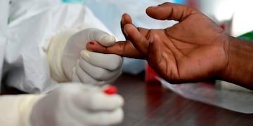Medical staff conduct a blood sample test for the COVID-19 coronavirus on a person arriving from a red zone, at a community health centre in Samahani, Aceh province on June 5, 2020\u002E (Photo by CHAIDEER MAHYUDDIN / AFP)