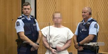 TOPSHOT - Brenton Tarrant, the man charged in relation to the Christchurch massacre, makes a sign to the camera during his appearance in the Christchurch District Court on March 16, 2019\u002E - A right-wing extremist who filmed himself rampaging through two mosques in the quiet New Zealand city of Christchurch killing 49 worshippers appeared in court on a murder charge March 16, 2019\u002E Australian-born 28-year-old Brenton Tarrant appeared in the dock wearing handcuffs and a white prison shirt, sitting impassively as the judge read a single murder charge against him\u002E A raft of further charges are expected\u002E (Photo by Mark Mitchell / POOL / AFP) / EDS NOTE HIS FACE MUST BE PIXELATED\u002E\u002EONLY HIS FACE--