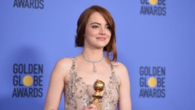 Emma Stone poses with her award for best actress in a musical or comedy for her role in