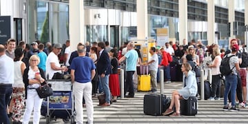People wait outside the Munich Airport in Munich, Germany, Tuesday, Aug\u002E 27, 2019\u002E Munich Airport says it has closed some of its terminals because a person has likely entered the \