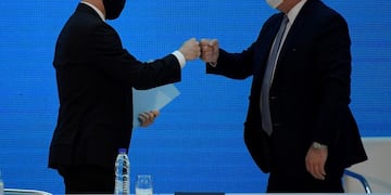 Argentina's President Alberto Fernandez (R) greets Economy Minister Martin Guzman before attending a press conference to give details about the agreement with major private creditors to restructure Argentina's sovereign debt, at the Casa Rosada Presidential Palace, in Buenos Aires, Argentina August 31, 2020\u002E Juan Mabromata/Pool via REUTERS
