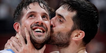 Facundo Campazzo of Argentina, right, kisses teammate Nicolas Laprovittola as they celebrate after beating France in their semifinal match against in the FIBA Basketball World Cup at the Cadillac Arena in Beijing, Friday, Sept\u002E 13, 2019\u002E (AP Photo/Mark Schiefelbein)