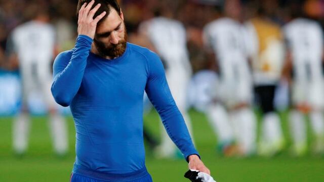 Barcelona's Argentinian forward Lionel Messi walks on the pitch at the end of the UEFA Champions League quarter-final second leg football match FC Barcelona vs Juventus at the Camp Nou stadium in Barcelona on April 19, 2017.nThe game ended with a draw and Juventus is qualified for the semis. / AFP PHOTO / PAU BARRENA