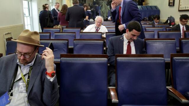 Glenn Thrush (L), chief White House political correspondent for the The New York Times, works in the briefing room after being excluded from a gaggle at the White House in Washington, U.S., February 24, 2017. Several major news organizations including CNN