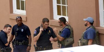 Police gather near the scene of a reported shooting in Charleston, S\u002EC\u002E, on Thursday, Aug\u002E24, 2017\u002E Authorities say a disgruntled employee shot one person and is holding hostages in a restaurant in an area that is popular with tourists\u002E Mayor John Tecklenburg said at a news conference that the shooting was not an act of terrorism or racism\u002E (Grace Beahm Alford /The Post And Courier via AP)