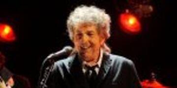 FILE  - In this Jan. 12, 2012, file photo, Bob Dylan performs in Los Angeles. Dylan, who was named the winner of the 2016 Nobel Prize in literature on Oct. 13, 2016, says he u201cabsolutelyu201d wants to attend the Nobel Prize Award Ceremony u201cif itu2019s at all possi