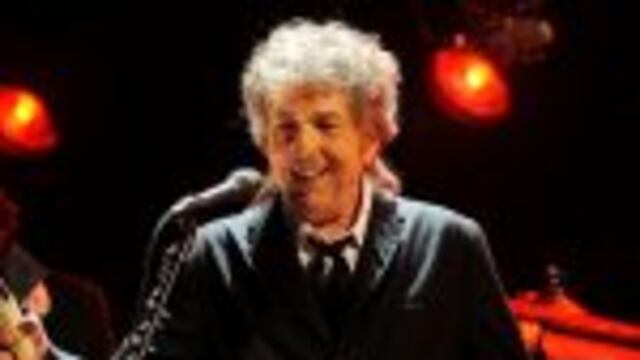 FILE - In this Jan. 12, 2012, file photo, Bob Dylan performs in Los Angeles. Dylan, who was named the winner of the 2016 Nobel Prize in literature on Oct. 13, 2016, says he u201cabsolutelyu201d wants to attend the Nobel Prize Award Ceremony u201cif itu2019s at all possi