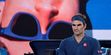 Switzerland's Roger Federer waits in his chair during a break in his third round match against United States' Taylor Fritz at the Australian Open tennis championships in Melbourne, Australia, Friday, Jan\u002E 18, 2019\u002E (AP Photo/Kin Cheung)