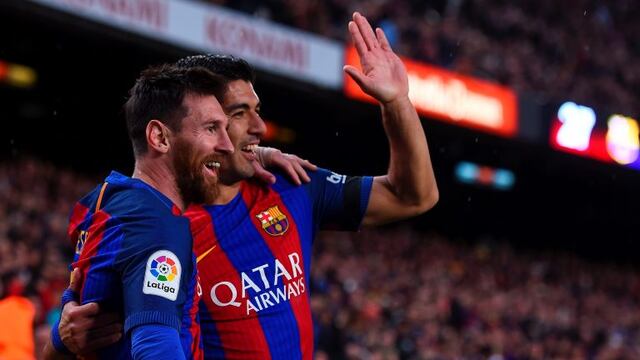 Barcelona's Argentinian forward Lionel Messi (L) is congratulated by Barcelona's Uruguayan forward Luis Suarez after scoring during the Spanish league football match FC Barcelona vs Sevilla FC at the Camp Nou stadium in Barcelona on April 5, 2017. / AFP P