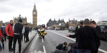 An injured person is assisted after an incident on Westminster Bridge in London, Britain March 22, 2017. REUTERS/Toby Melville