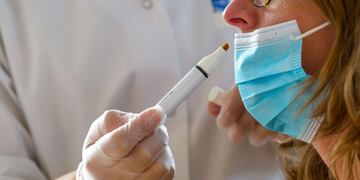A nurse performs an olfactory test on Martine Bailly, a patient infected with Covid-19 in March 2020, in the office of the otolaryngologist doctor Duc Trung Nguyen, at the Nancy university hospital (CHRU) in Vandoeuve-les-Nancy, northeastern France, on October 28, 2020\u002E - Doctor Duc Trung Nguyen works on olfactory rehabilitation with Covid-19-infected patients, as well as all pathologies responsible for olfaction loss\u002E (Photo by JEAN-CHRISTOPHE VERHAEGEN / AFP)