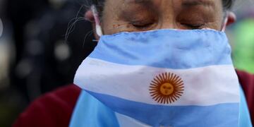 A protester wearing an Argentine flag as a mask cries as he demands the end of the government-ordered lockdown to curb the spread of the new coronavirus in Buenos Aires, Argentina, Thursday, July 9, 2020\u002E People protested across the country during the local Independence Day holiday, the handling of the pandemic by the administration of President Alberto Fernandez\u002E (AP Photo/Natacha Pisarenko)