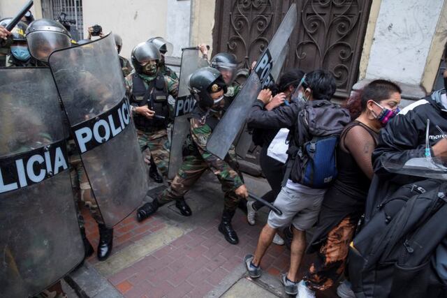 Supporters of Peru's former President Martin Vizcarra are stopped by police from marching to Congress where lawmakers voted the previous night to remove Vizcarra from office, in Lima, Peru, Tuesday, Nov\u002E 10, 2020\u002E Congress voted to oust Vizcarra over his handling of the new coronavirus pandemic and unproven allegations of corruption years ago\u002E (AP Photo/Rodrigo Abd)