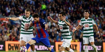 FC Barcelona's Lionel Messi, second left, duels for the ball during the Spanish La Liga soccer match between FC Barcelona and Eibar at the Camp Nou stadium in Barcelona, Spain, Sunday, May 21, 2017. (AP Photo/Manu Fernandez)
