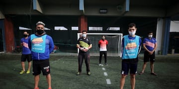 Amateur players stand ahead of a soccer match at the Play Futbol 5 local club in Pergamino, Argentina, Wednesday, July 1, 2020\u002E In order to continue playing amid government restrictions to curb the spread of the new coronavirus, the club divided its soccer field into 12 rectangles to mark limited areas for each player, keeping them from making physical contact\u002E (AP Photo/Natacha Pisarenko)