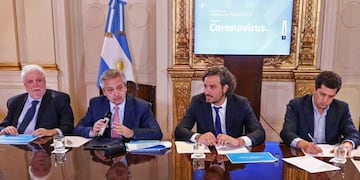 This handout picture released by the Argentine Presidency shows Argentina's President Alberto Fernandez (2-L), Health Minister Gines Garcia (L), Chief Cabinet Santiago Cafiero (2-R) and Interior Minister Eduardo de Pedro, attending a cabinet meeting to evaluate measures to contain the new Coronavirus, COVID-19, at Casa Rosada, in Buenos Aires, on March 10, 2020\u002E (Photo by - / ARGENTINE PRESIDENCY / AFP)