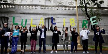 People hold letters reading in Spanish \