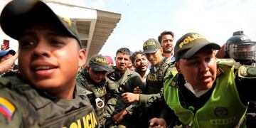 Colombian police escort a Venezuelan soldier who surrendered at the Simon Bolivar international bridge, where Venezuelans tried to deliver humanitarian aid despite objections from President Nicolas Maduro, in Cucuta, Colombia, Saturday, Feb\u002E 23, 2019\u002E Opposition leader Juan Guaido says the military is key to restoring democracy in Venezuela, although masses of soldiers appear to remain loyal to Maduro\u002E (AP Photo/Fernando Vergara)