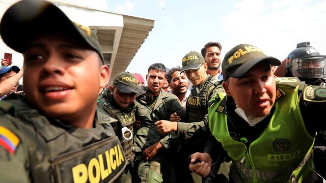 Colombian police escort a Venezuelan soldier who surrendered at the Simon Bolivar international bridge, where Venezuelans tried to deliver humanitarian aid despite objections from President Nicolas Maduro, in Cucuta, Colombia, Saturday, Feb\u002E 23, 2019\u002E Opposition leader Juan Guaido says the military is key to restoring democracy in Venezuela, although masses of soldiers appear to remain loyal to Maduro\u002E  (AP Photo/Fernando Vergara)