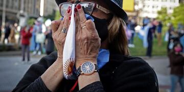A woman takes part in a demonstration called by small businessmen affected by the government's mandatory quarantine imposed for more than 13 weeks, to protest against the quarantine and the expropriation of the Vicentin agro-industrial company on the Obelisk in Buenos Aires, June 20, 2020\u002E - Argentine President Alberto Fernandez announced on June 8 the nationalisation of soy giant Vicentin, which was the country's largest grain exporter until it entered a crisis at the end of last year\u002E (Photo by ALEJANDRO PAGNI / AFP)