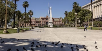 A pedestrian walks through the near deserted Plaza de Mayo in Buenos Aires, Argentina, on Friday, March 20, 2020\u002E Argentina imposed a nationwide lockdown to stem the coronavirus pandemic, marking one of the strictest measures taken by any Latin American nation\u002E Photographer: Sarah Pabst/Bloomberg