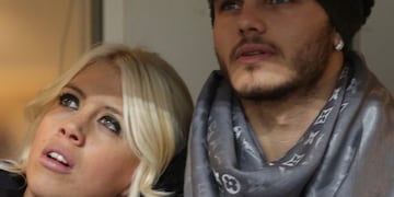 FILE - In this Jan\u002E 13, 2014 file photo, Inter Milan forward Mauro Icardi, of Argentina, is flanked by his wife Wanda Nara as they sit in the stands prior to a Serie A soccer match between Inter Milan and Chievo, at the San Siro stadium in Milan, Italy, Monday, Jan\u002E13, 2014\u002E Two months ago, Mauro Icardi was one of Inter Milan's favored players, on Thursday, Feb\u002E 14, 2019, he was training with just a handful of teammates at their training ground after a rapid fall from grace after Icardi and Inter have been in protracted talks over renewing his contract, which expires in 2021, with agent-wife Wanda Nara being particularly outspoken over the past month\u002E (AP Photo/Luca Bruno)