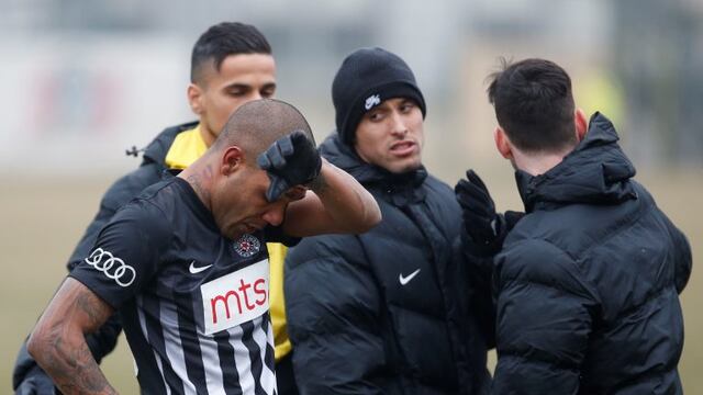 Partizan Belgrade's Brazilian player Everton Luiz, left, leaves the field during a Serbian championship match between Rad and Partizan, in Belgrade, Serbia, Sunday, Feb. 19, 2017.  Luiz was in tears after suffering persistent racist chants during his team