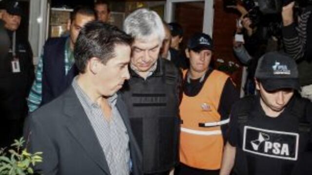 Argentine businessman Lazaro Baez, center, is escorted by police after being arrested as part of an investigation into alleged money laundering, at an airport on the outskirts of Buenos Aires, Argentina, late Tuesday, April 5, 2016. Baez, who got large pu