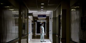 TOPSHOT - Dr Mario Grossmann poses for a photo during his 24hs shift, at the emergency area of the Doctor Alberto Antranik Eurnekian Public Hospital in Ezeiza, in the outskirts of Buenos Aires on August 29, 2020, amid the new coronavirus, COVID-19, pandemic\u002E - Dr Grossmann, a professor, head of practical work of semiology and internal medicine at Buenos Aires University (UBA) and chair head of semiology and internal medicine at Universidad Abierta Interamericana (UAI) teaches from the hospital through video calls to students of 4th and 5th year\u002E (Photo by ARIEL TIMY TORRES / AFP)