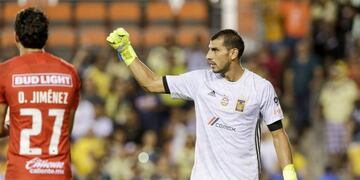 HOUSTON, TX - AUGUST 20: Nahuel Guzman #1 of Tigres UANL celebrates after blocking a shot as Oscar Jimenez #27 of Club America reacts in overtime penalty kicks during the Leagues Cup semifinal match at BBVA Compass Stadium on August 20, 2019 in Houston, Texas\u002E Tim Warner/Getty Images/AFP\n== FOR NEWSPAPERS, INTERNET, TELCOS & TELEVISION USE ONLY ==