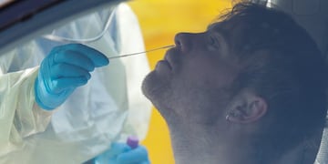 Medical staff take a COVID-19 test from a visitor to a drive through community based assessment centre in Christchurch, New Zealand, Thursday, Aug\u002E 13, 2020\u002E Health authorities in New Zealand are scrambling to trace the source of a new outbreak of the coronavirus as the nation's largest city, Auckland, goes back into lockdown\u002E (AP Photo/Mark Baker)