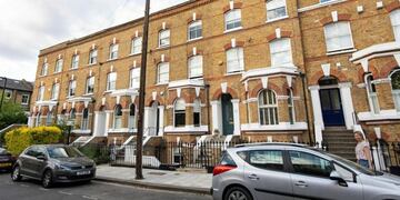 General view of the road in Clapham, south London, Monday July 1, 2019, where the body of a suspected stowaway is believed to have fallen from a passenger plane and was found in a garden, after police attended Sunday following the discovery\u002E It is thought the body fell from the landing gear of a Kenya Airways flight as it prepared to land at Heathrow Airport\u002E (Dominic Lipinski/PA via AP)