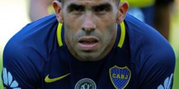 (FILES) This file photo taken on December 04, 2016 showing Boca Juniors forward Carlos Tevez poses wearing the Brazil's Chapecoense football team logo in his jersey to pay homage for the 71 victims of the plane crash in the Colombian mountains earlier thi