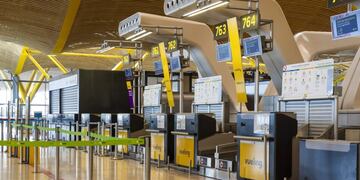Empty Vueling Airlines SA, a unit of International Airlines Group SA (IAG SA), check-in desks stand in the departures terminal at Madrid Barajas airport, operated by Aena SA, in Madrid, Spain, on Sunday, March 15, 2020\u002E Spain declared a state of emergency effective immediately for 15 days, significantly limiting mobility in the country as the government seeks to stop the expansion of the novel coronavirus\u002E Photographer: Angel Navarrete/Bloomberg