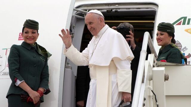 Pope Francis waves as he boards a plane on his way to Cairo, Egypt, at Rome's Fiumicino inernational airport, Friday, April 28, 2017. Francis is travelling to Egypt for a two-day trip aimed at presenting a united Christian-Muslim front that repudiates violence committed in God's name. (L'Osservatore Romano/Pool Photo via AP)