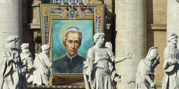 A tapestry hanged on the facade of St Peter's basilica shows a portrait of Italian Lodovico Pavoni during a canonization mass led by Pope Francis on October 16, 2016 at St Peter's square in Vatican. Pope Francis canonises Argentine