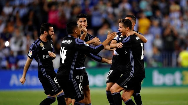 Real Madrid's Cristiano Ronaldo celebrates with teammates at the end of a Spanish La Liga soccer match between Malaga and Real Madrid in Malaga, Spain, Sunday, May 21, 2017. Real Madrid wins the Spanish league for the first time in five years, avoiding its biggest title drought since the 1980s. (AP Photo/Daniel Tejedor)