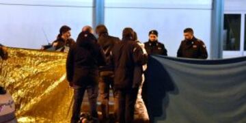 Italian police cordon off an area around a body after a shootout between police and a man in Milan's Sesto San Giovanni neighborhood, early Friday, Dec. 23, 2016. Italy's interior minister Marco Minniti says the man killed in an early-hours shootout in Milan is