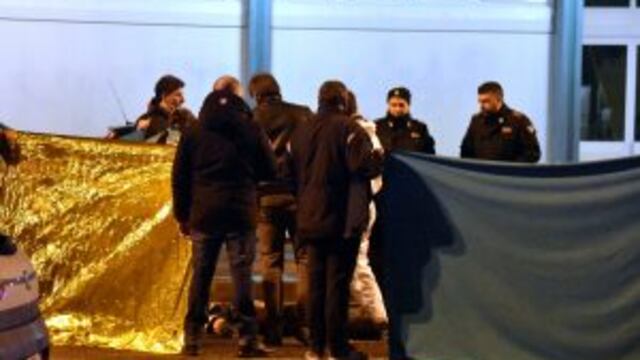 Italian police cordon off an area around a body after a shootout between police and a man in Milan's Sesto San Giovanni neighborhood, early Friday, Dec. 23, 2016. Italy's interior minister Marco Minniti says the man killed in an early-hours shootout in Milan is