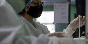 Women place a handmade swab in a sewing machine at the Parque Tecnologico del Cerro in Montevideo on October 1, 2020\u002E - Former workers of the textile sector are making handmade swabs to be distributed to collect samples for COVID-19 tests, as part of a project of the Design School of the Architecture, Design and Urbanism Faculty alongside the Chemistry and the Engineering Faculties of the University of the Republic in Uruguay\u002E (Photo by Pablo PORCIUNCULA / AFP)