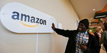 In this Monday, Oct\u002E 16, 2017, photo, Zavian Tate, a student at the University of Alabama at Birmingham, pushes a large Amazon Dash button, in Birmingham, Ala\u002E The large Dash buttons are part of the city's campaign to lure Amazon's second headquarters to Birmingham\u002E (AP Photo/Brynn Anderson)