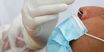 FILE PHOTO: A health worker administers a nasal swab to a patient at a testing site for the coronavirus disease (COVID-19) installed at the Bassin de la Villette in Paris, France, August 25, 2020\u002E  REUTERS/Gonzalo Fuentes/File Photo