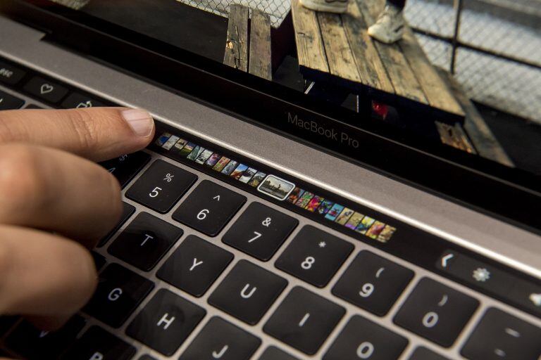 An attendee demonstrates the Touch Bar on the new MacBook Pro laptop computer during an event at Apple Inc. headquarters in Cupertino, California, U.S., on Thursday, Oct. 27, 2016. Apple Inc. introduced the first overhaul of its MacBook Pro laptop in more