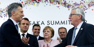 In this Handout released by Argentina's Presidency, Argentina's President Mauricio Macri ( L) and European Commission President Jean-Claude Juncker (R) greet eachother as France's President Emmanuel Macron (2-L), Spanish President Pedro Sanchez (3-L), German Chancellor Angela Merkel (C) and EU Council President Donald Tusk look on during a press conference at the G20 Osaka Summit in Osaka on June 29, 2019\u002E - European farmers and environmentalists have denounced a historic trade deal signed between the EU and South American countries as a \
