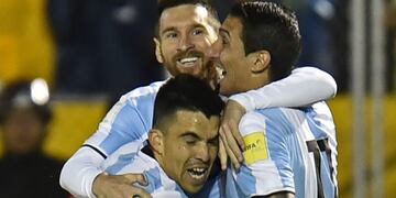 Argentina's Lionel Messi (C) celebrates with teammates Marcos Acuna (L) and Angel Di Maria after scoring against Ecuador during their 2018 World Cup qualifier football match in Quito, on October 10, 2017\u002E / AFP PHOTO / Pablo COZZAGLIO